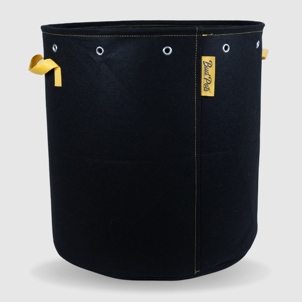 Black BudPots fabric pot 25Ga with yellow handles and a visible brand logo on a light gray background