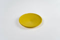 Yellow BudTrainer BudCups bottom insert for improved drainage and healthy cannabis root development.