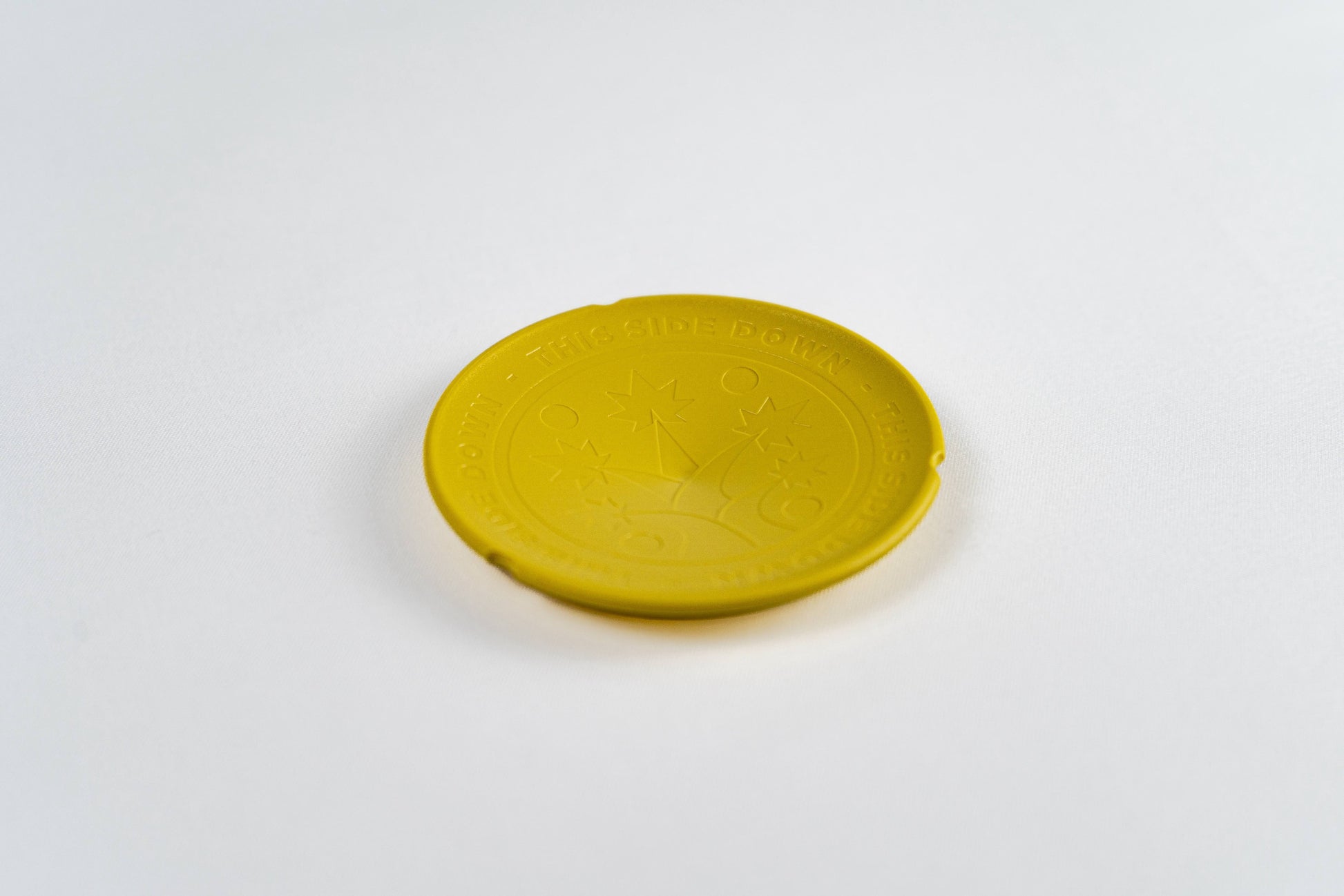 Yellow BudTrainer BudCups bottom insert for improved drainage and healthy cannabis root development.