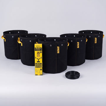 Five black BudPots fabric grow bags with a yellow BudClips 40-pack sleeve and a coil of black BudHuggers garden wire in front, on a plain grey background.