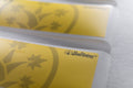 Two yellow Gardening Notes labels, blank, with the BudTrainer mark printed on them.